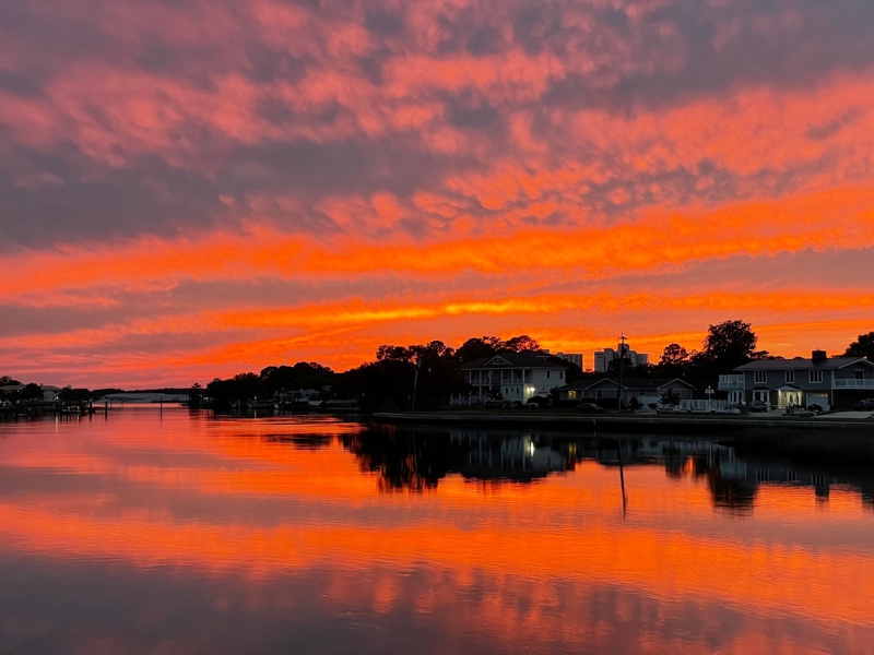 Waterfront property at sunset with houses along creek shoreline in Virginia